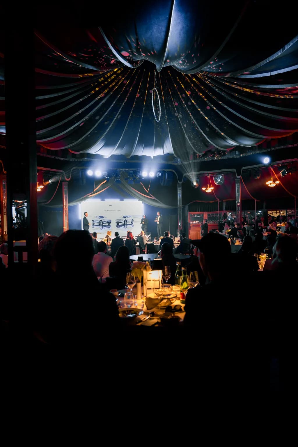 Guests at festively laid tables in the MIRAGE mirror tent during the Geely Brand Launch Night